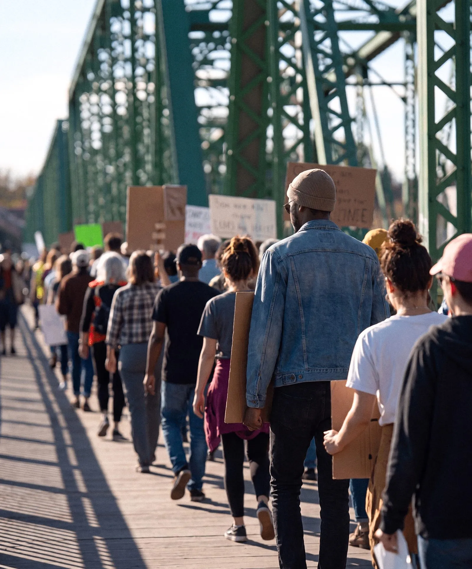Community members marching with signs across the bridge in New Hope, Pennsylvania